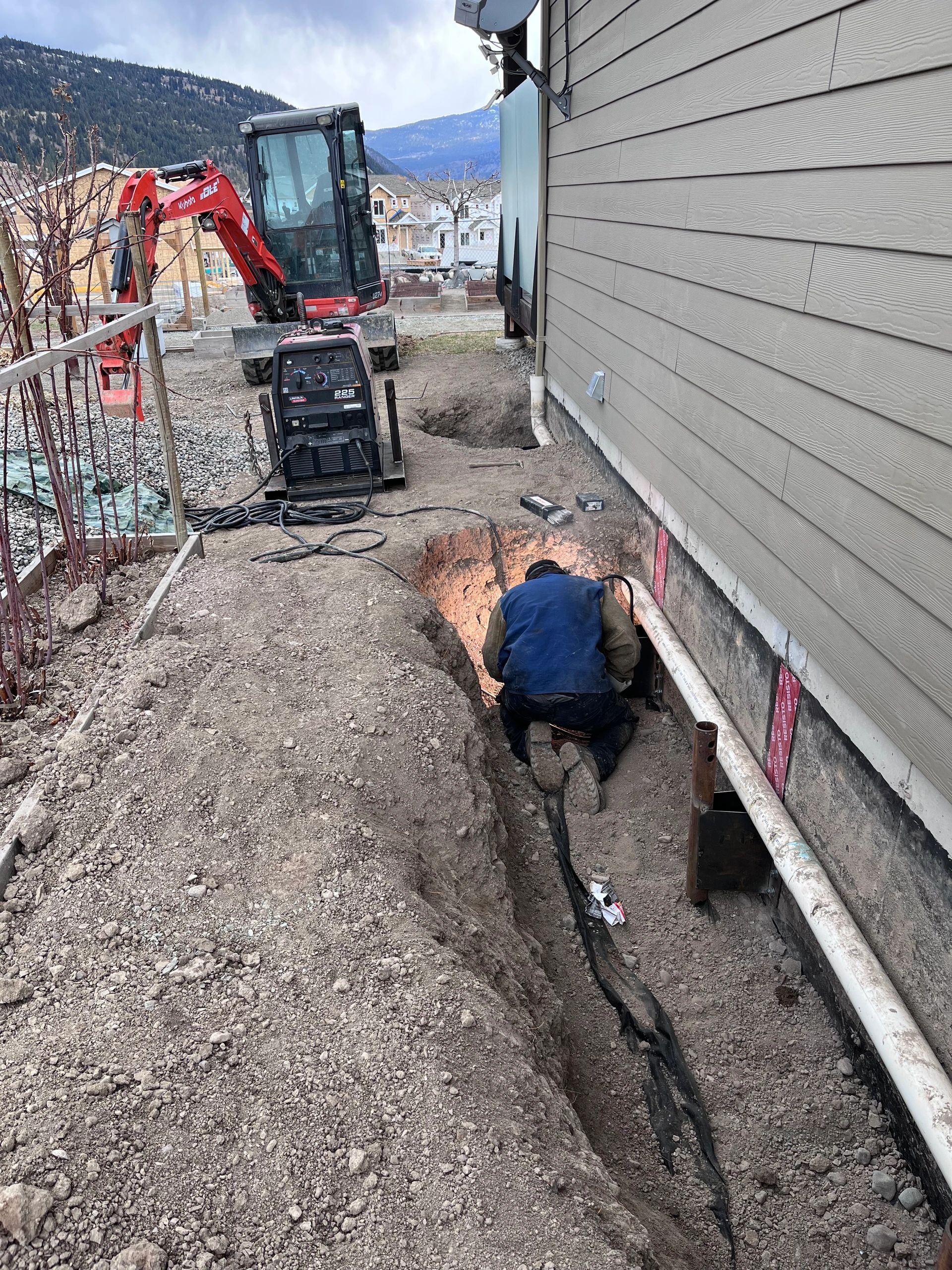 Underpinning piles installed to stabilize a house that experienced severe settlement.